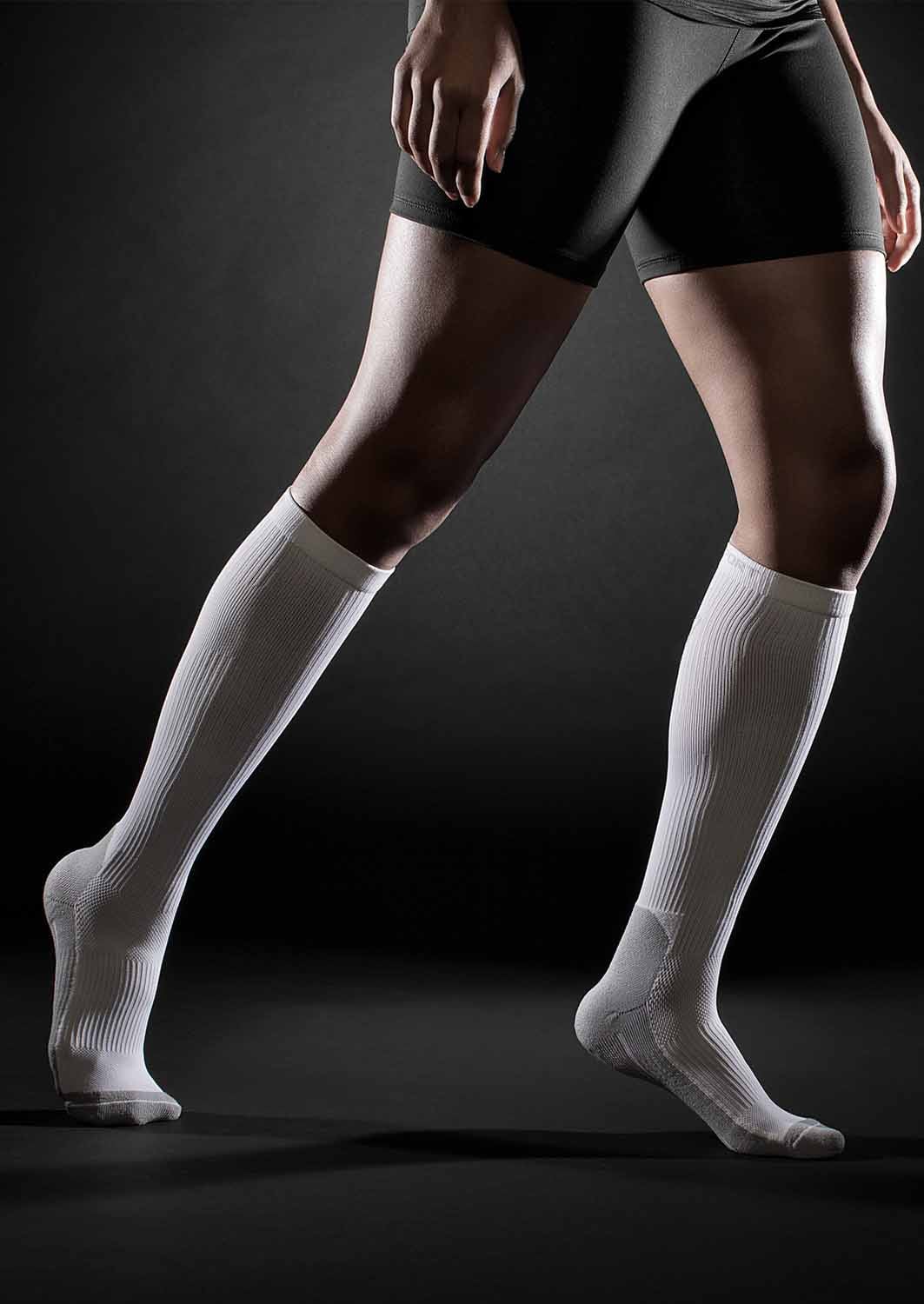 TheraSport 15-20 mmHg Athletic Recovery Knee High Compression Socks - White - Manufacturer lifestyle view