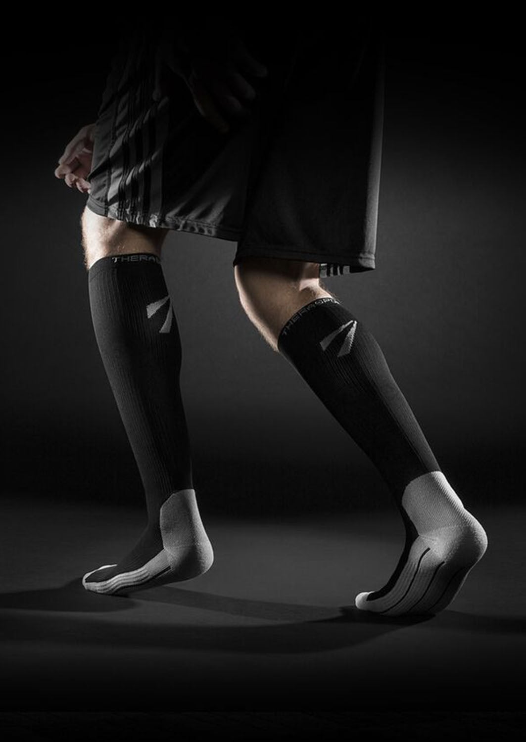 TheraSport 15-20 mmHg Athletic Recovery Knee High Compression Socks - Black - Manufacturer lifestyle view