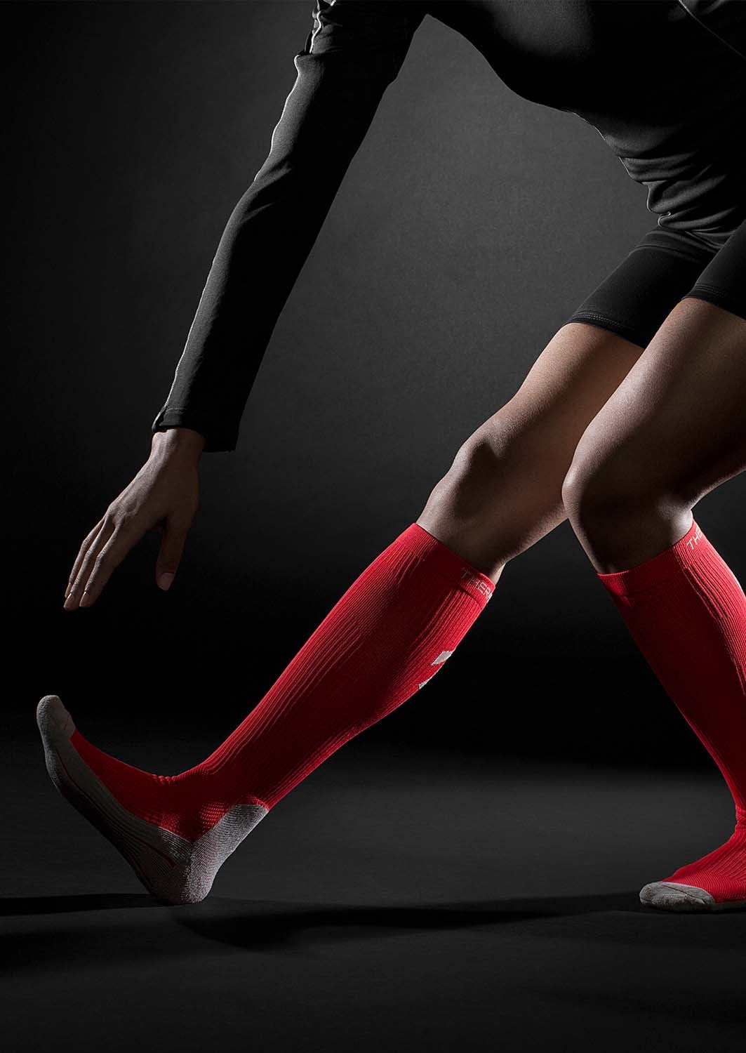 TheraSport 15-20 mmHg Athletic Recovery Knee High Compression Socks - Red - Manufacturer lifestyle view